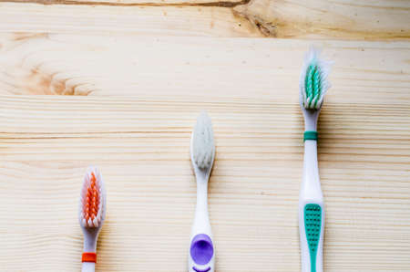 Old toothbrush on wooden background. Cinematic toneの写真素材