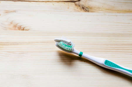 Old toothbrush on wooden background. Cinematic toneの写真素材