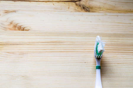 Old toothbrush on wooden background. Cinematic toneの写真素材