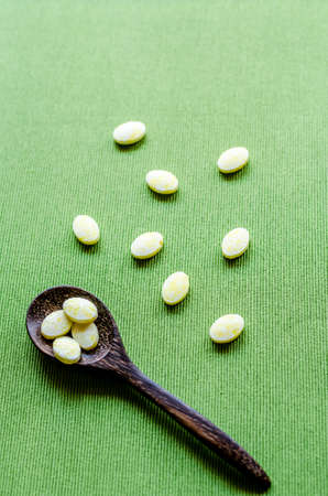 medicine tablets on green tablecloth background