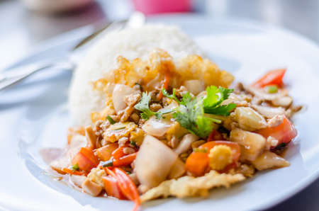 Rice topped with sweet and  sour pork and fried egg, thai and chinese food, selective focusの写真素材