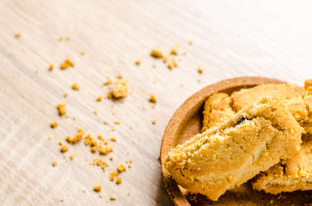 Close up Apple strudel crispy pies on wood background.