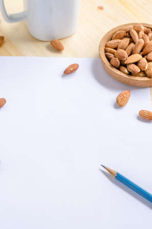 Almond snack on wooden table: breaking time in officeの写真素材
