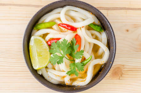 Hot and spicy udon noodle on wooden backgroundの写真素材