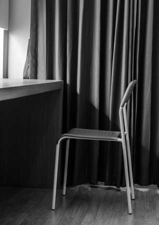 lonely chair in the hotel room: black and white toneの写真素材