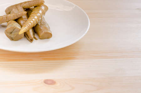 Bamboo shoots in white dish on wooden table background