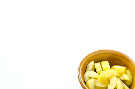 mango compote in brown bowl on white backgroundの写真素材