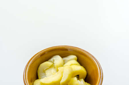 mango compote in brown bowl on white backgroundの写真素材