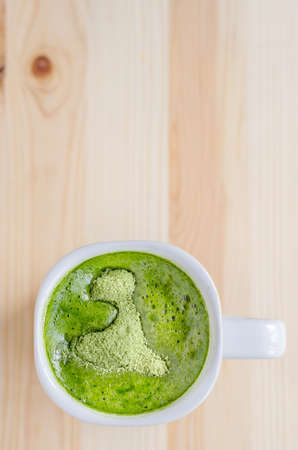 Milk green tea on wooden tableの写真素材