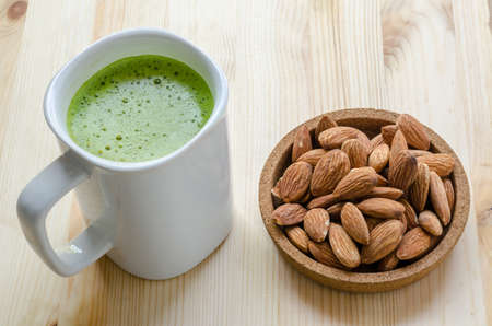 Hot green tea latte in lazy time with almonds nutの写真素材
