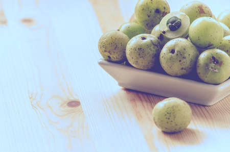 Indian Gooseberry: berry of high vitamin-c on the wooden background: vintage toneの写真素材