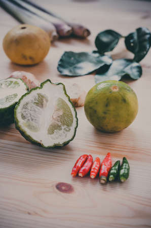 Herb ingredient of Tom Yum spicy soup Thai food cuisine on wooden backgroundの写真素材