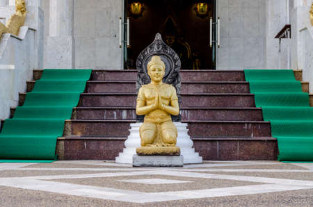 Gold color Statue in thai templeの写真素材