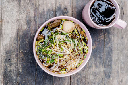 Thai style beef noodle on wooden tableの写真素材