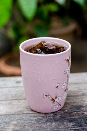 A glass of cola soft drink with iceの写真素材