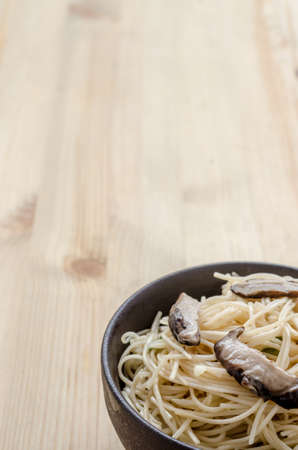Fried noodle in black bowl on wooden table, Thai street foodの写真素材