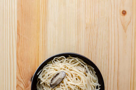 Fried noodle in black bowl on wooden table, Thai street foodの写真素材