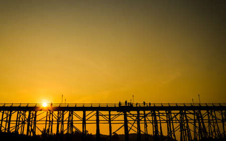 Silhouetted bridge at sunset, Sangkla, Kanjanaburi Province, Thailandの写真素材