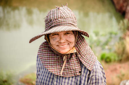RATCHABURI PROVINCE, THAILAND-MARCH 18: Smile of the old women, she working in Municipal waste disposal open dump process.  Dump site at Ratchaburi Province on MARCH 18 , 2016 in RATCHABURI PROVINCE THAILANDのeditorial素材
