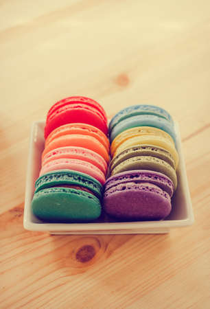 Colorful macaroons and green tea on wooden table background: vintage toneの写真素材