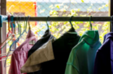 Blur clothing hang on hangers in houseの写真素材
