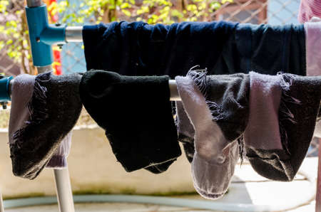 Used socks hang on hanger in house