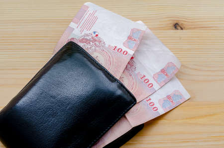 Old black wallet and three hundred bathの写真素材