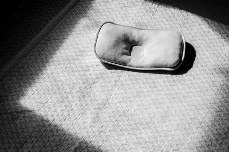 Black and white pillow on the empty bed