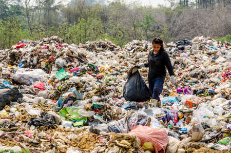 RATCHABURI PROVINCE, THAILAND-MARCH 18: People working in Municipal waste disposal open dump process.  Dump site at Ratchaburi Province on MARCH 18 , 2016 in RATCHABURI PROVINCE THAILANDのeditorial素材