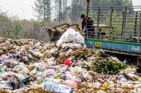 RATCHABURI PROVINCE, THAILAND-MARCH 18: People working in Municipal waste disposal open dump...
