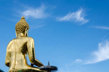 Gold color Statue in thai temple over blue skyの写真素材