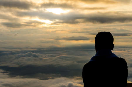 Silhouette of a man at the beautiful ries on the mountain and cloud. Backgroundの写真素材