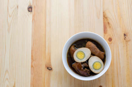 Egg and pork in brown sauce on wooden background, Thai Cuisineの写真素材