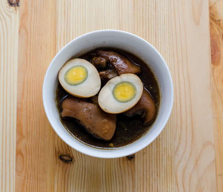 Egg and pork in brown sauce on wooden background, Thai Cuisineの写真素材