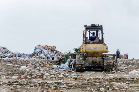 CHONBURI PROVINCE, THAILAND-JULY 13: People working in Municipal waste disposal open dump process.  Dump site at Chonburi Province on JULY 13 , 2016 in CHONBURI PROVINCE THAILANDのeditorial素材