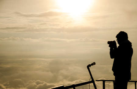 Silhouette of man at the beautiful ries on the mountain and cloud. Backgroundの写真素材