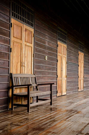 Old wooden bench in the wooden houseの写真素材
