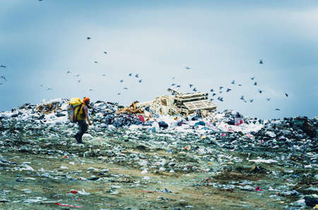 CHONBURI PROVINCE, THAILAND-JULY 13: Picture blur of people working in waste disposal open dump...