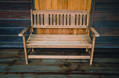 Old wooden bench in the wooden house, cinematic tone filterの写真素材