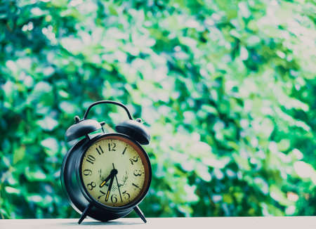 Old clock over the blur garden, cinematic tone filterの写真素材