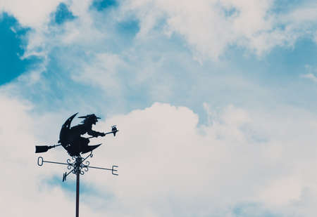 A witch on rooftop over the blue skyの写真素材