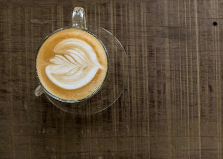 Hot late coffee on wooden background