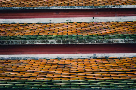 Old ceramic roof top in Thai temple, vintage tone picture