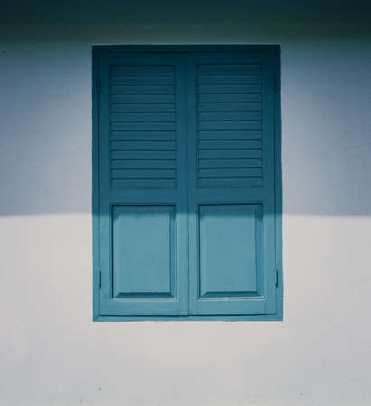 Old and vintage wooden  windows and white wallの写真素材