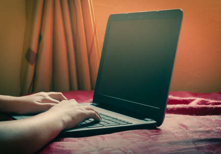 Work at home, hand and laptop computer in vintage tone.の写真素材