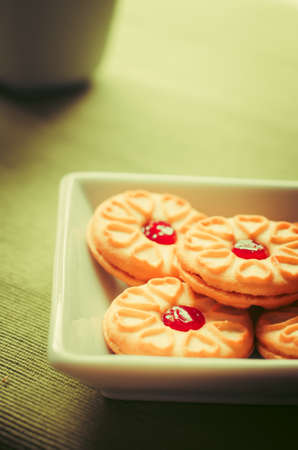 Sweet strawberry jam cookies for relax time. vintage tone