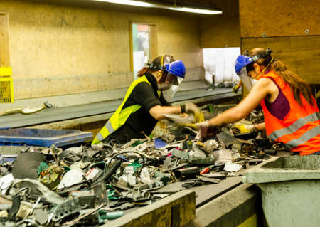 Man and women separated waste in recycling plantのeditorial素材