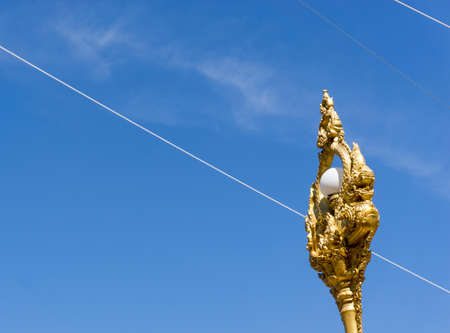 Thai style Lamp and Wires and signaling on the power poles over blue sky background