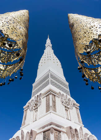 Stupa in Thai Buddhist temple over the blue sky background. Nakonpanom province in Thailandの写真素材