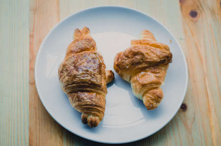 Croissant, Breaded bread on a wooden tra and white dishy delicious breakfast. vintage toneの写真素材